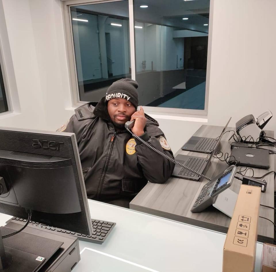 Kamsnotch Global Services security officer at a front desk answering a phone call